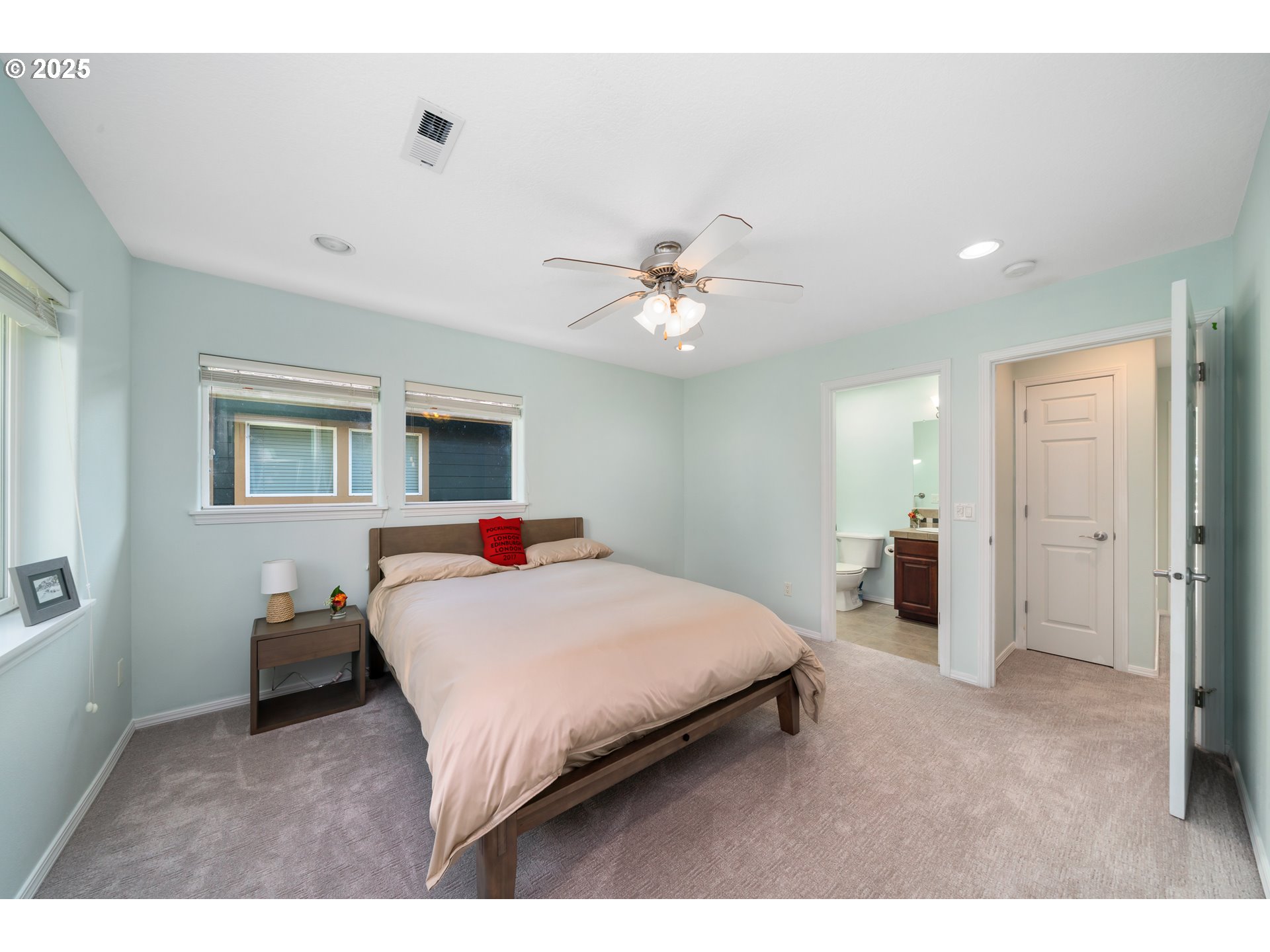 13150 D Street, Unit 12 Nehalem, OR 97131 - Photo 25 of 40 a bedroom with a bed and a chandelier