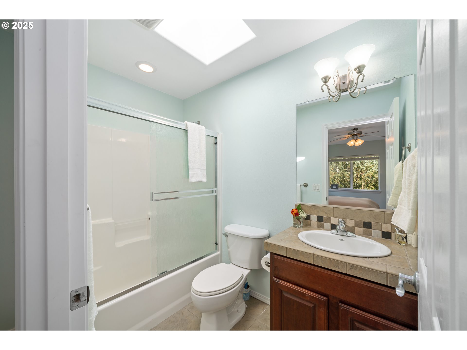 13150 D Street, Unit 12 Nehalem, OR 97131 - Photo 27 of 40 a bathroom with a toilet a sink a shower and a mirror