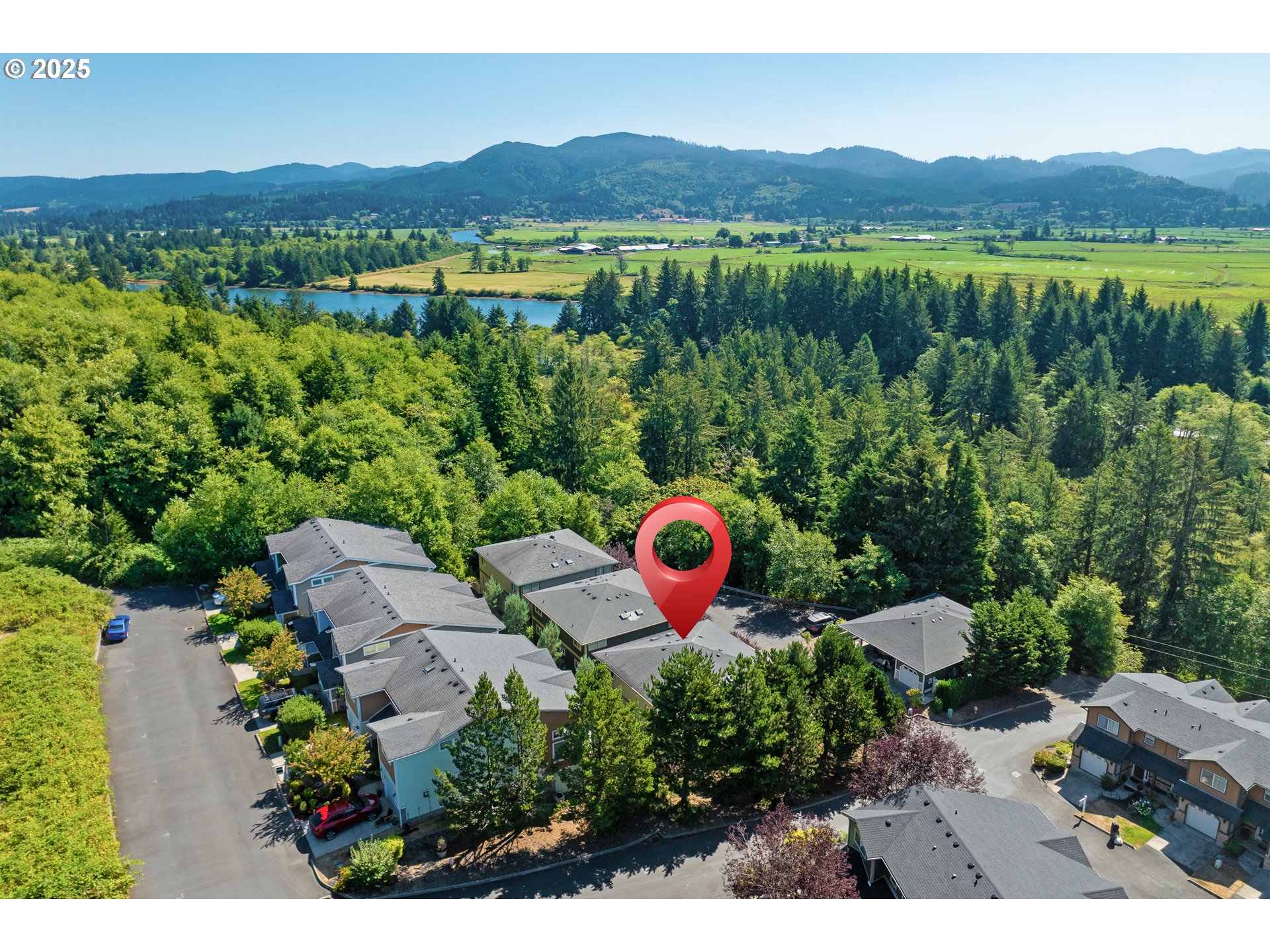 13150 D Street, Unit 12 Nehalem, OR 97131 - Photo 36 of 40 a view of a lush green field with mountains in the background