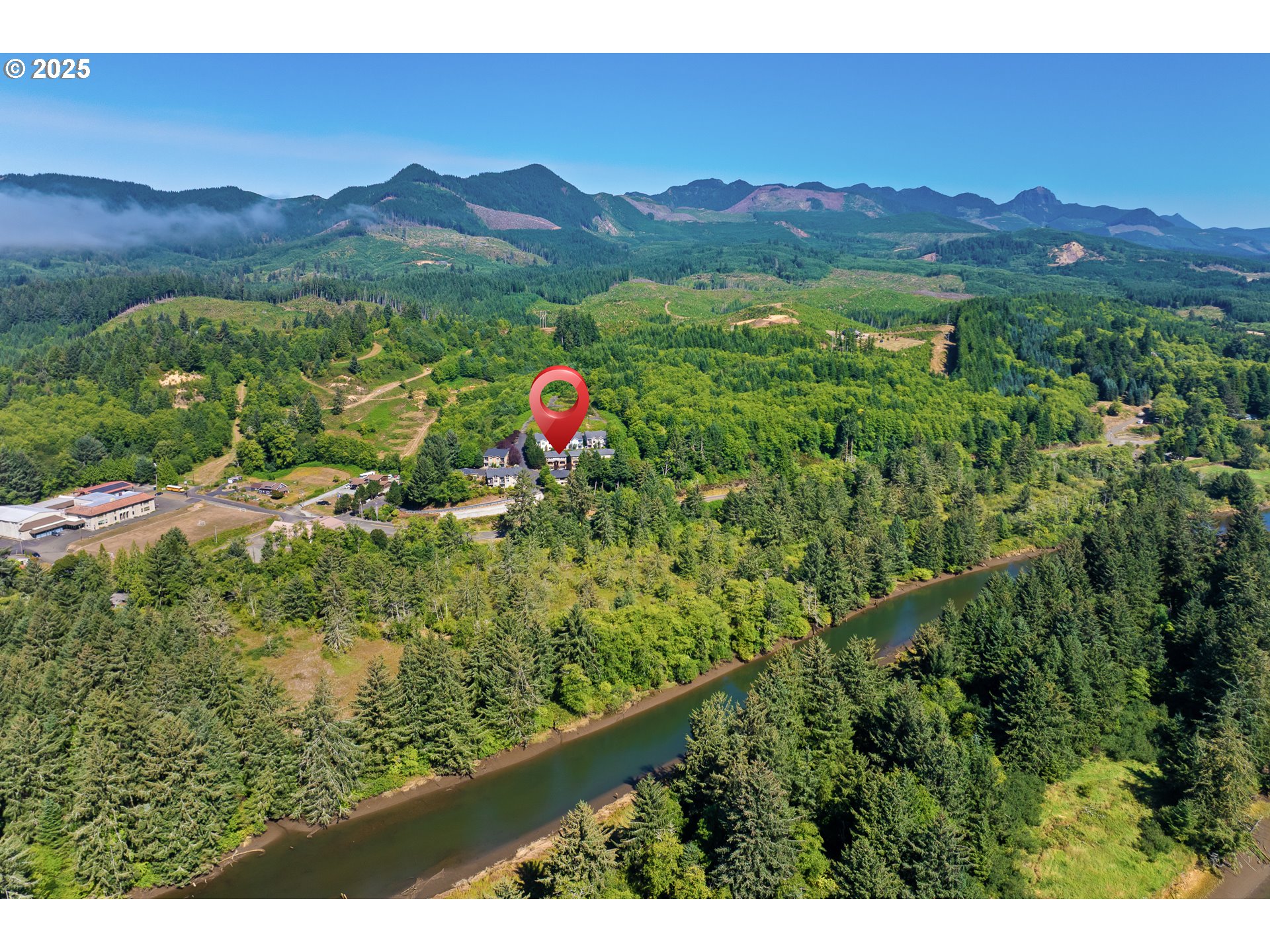13150 D Street, Unit 12 Nehalem, OR 97131 - Photo 39 of 40 a view of a lush green hillside and a houses