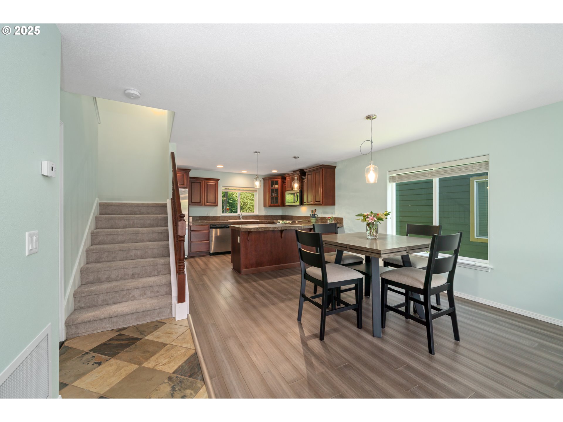 13150 D Street, Unit 12 Nehalem, OR 97131 - Photo 6 of 40 a view of a dining room with furniture and wooden floor