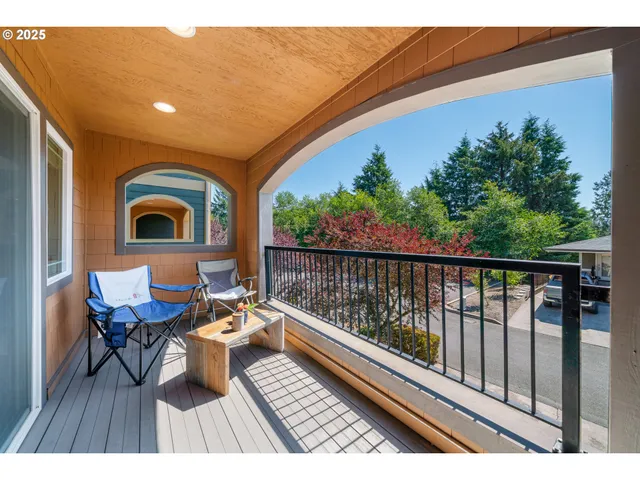 a roof deck with table and chairs