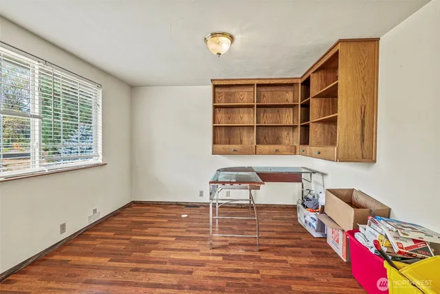 a room with a workspace and a window