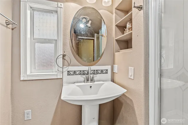 a bathroom with a sink and a mirror