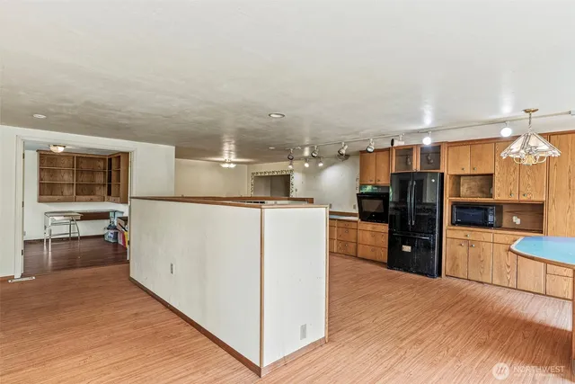 a kitchen with refrigerator and cabinets