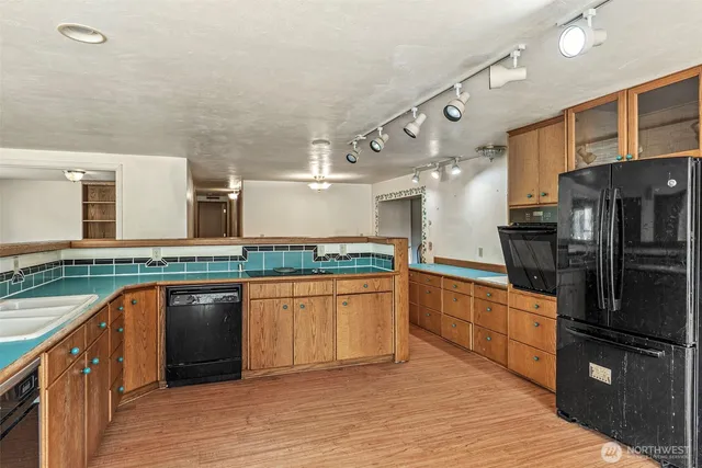 a kitchen with stainless steel appliances granite countertop a refrigerator and stove