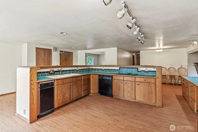 a large kitchen with stainless steel appliances granite countertop a stove and a sink