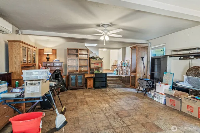 a living room with furniture a flat screen tv and kitchen view