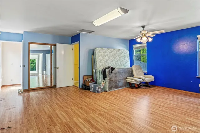 a view of a room with wooden floor and furniture