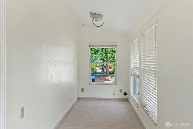 a view of a room that has a window and wooden floor