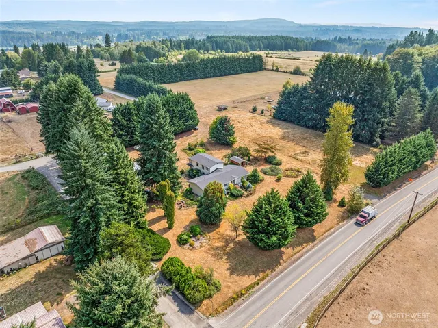 an aerial view of a house with garden space and lake view