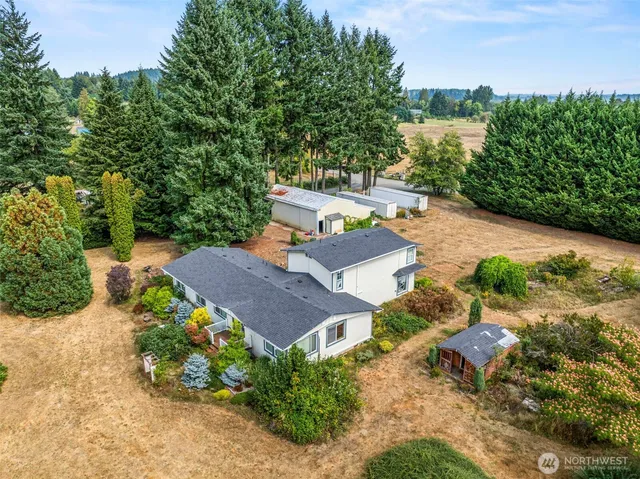 an aerial view of a house with garden space and street view
