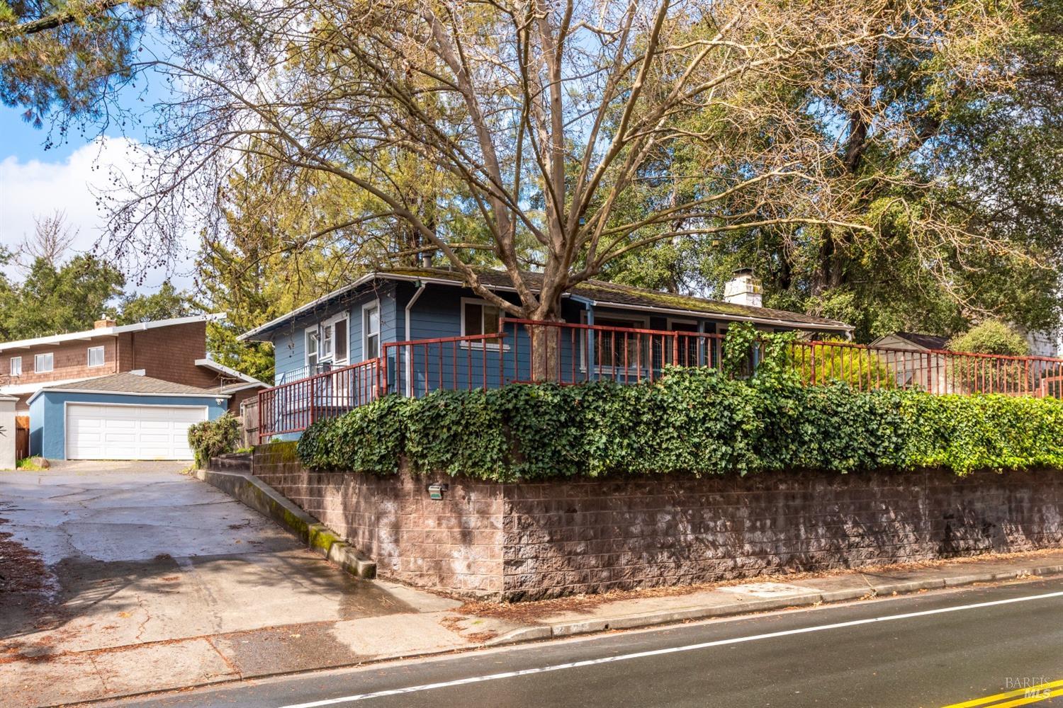 a front view of a house with a yard and potted plants