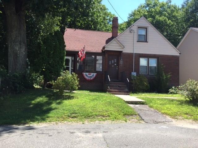 a front view of house with a garden