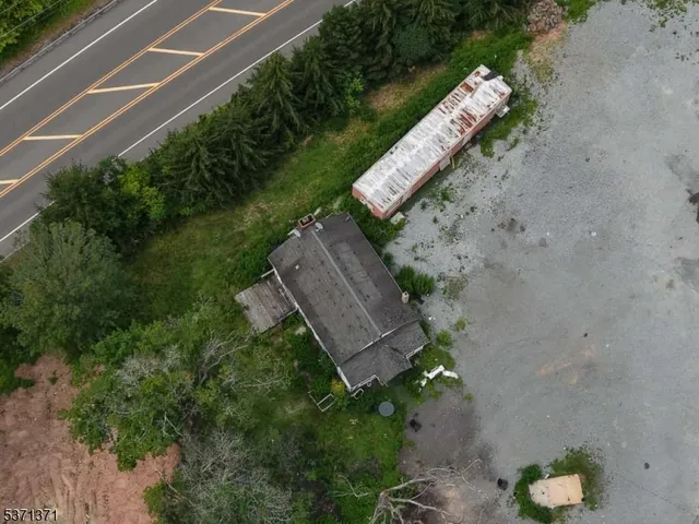 an aerial view of a house with a yard and outdoor space