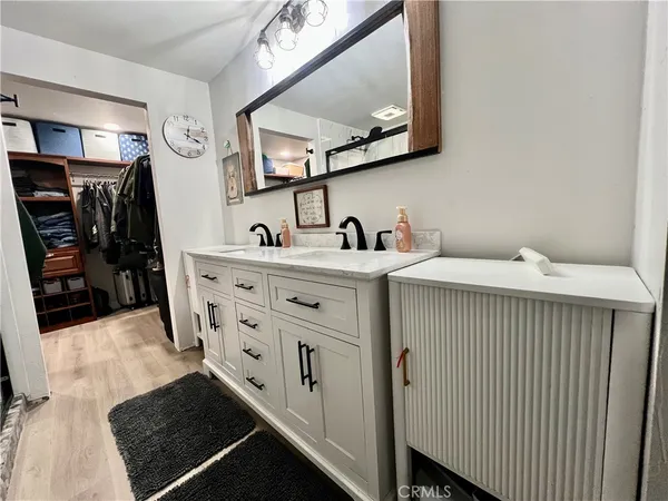 a bathroom with a sink double vanity and a mirror