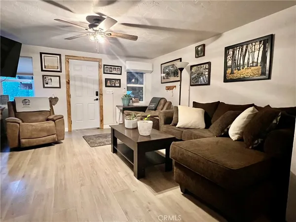 a living room with furniture and a ceiling fan