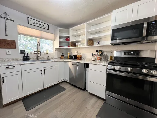 a kitchen with a sink stove and microwave
