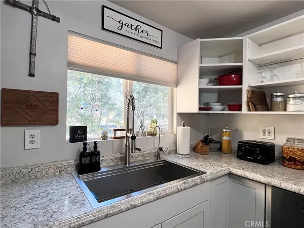a kitchen with a sink a counter and cabinets