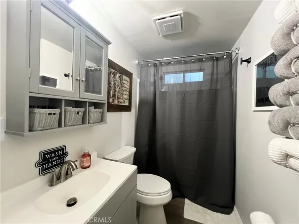 a bathroom with a sink mirror vanity and toilet