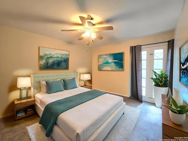 a bedroom with a large bed and a chandelier