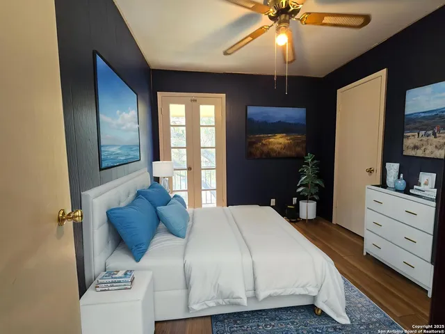 a bedroom with a bed and a chandelier