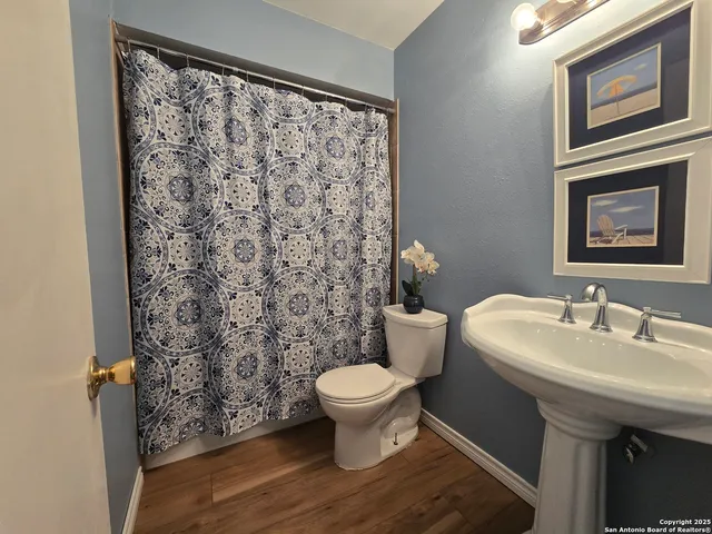 a bathroom with a sink toilet and a mirror