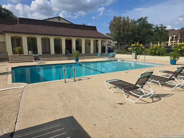 a view of a house with pool and a yard