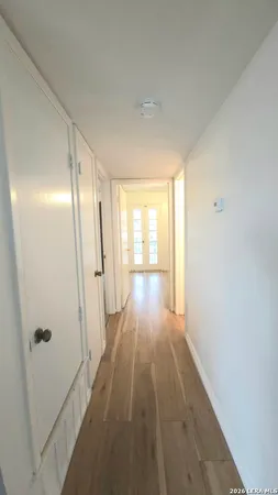 a view of hallway with wooden floor