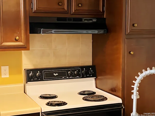 a close view of a stove a microwave and door