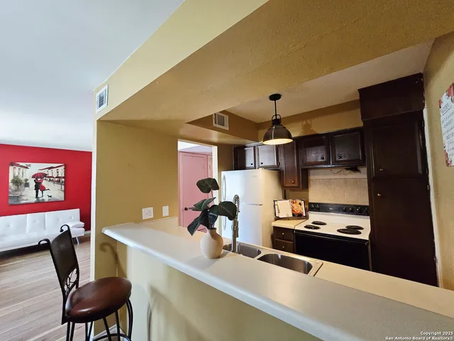 a kitchen with a table and chairs