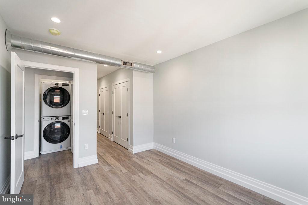 526 Brown Street, Unit 403 Philadelphia, PA 19123 - Photo 12 of 13 a view of a big room with wooden floor and cabinets