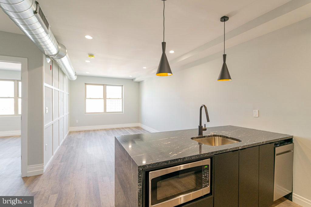 526 Brown Street, Unit 403 Philadelphia, PA 19123 - Photo 4 of 13 a kitchen with a sink a stove and a window