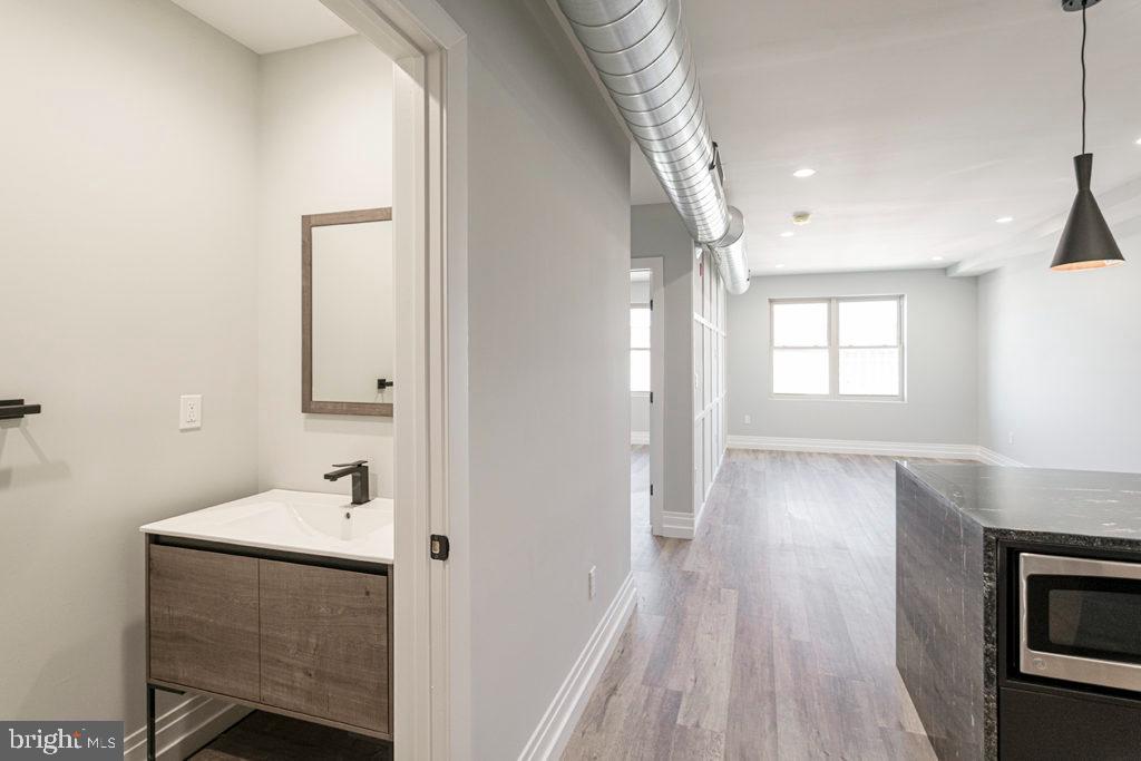 526 Brown Street, Unit 403 Philadelphia, PA 19123 - Photo 5 of 13 a bathroom with a sink and a mirror