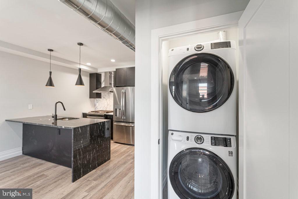 526 Brown Street, Unit 403 Philadelphia, PA 19123 - Photo 6 of 13 a view of a kitchen with stainless steel appliances granite countertop a sink and a stove