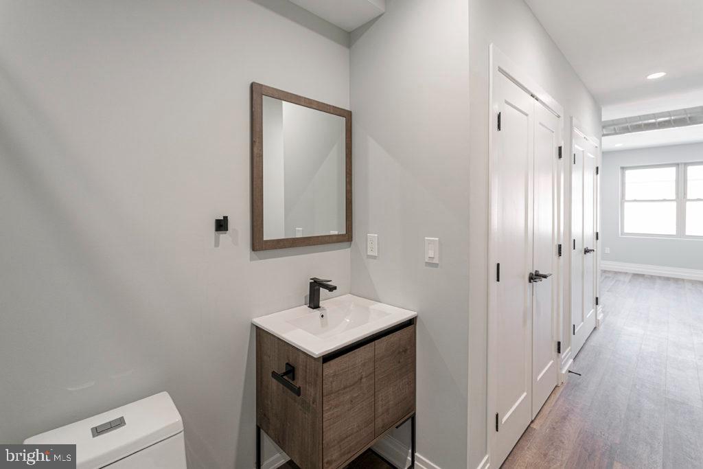 526 Brown Street, Unit 403 Philadelphia, PA 19123 - Photo 9 of 13 a bathroom with a sink a toilet and a mirror