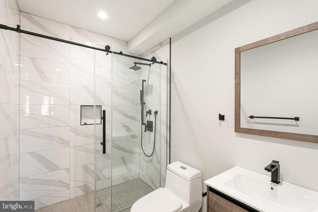 526 Brown Street, Unit 403 Philadelphia, PA 19123 - Photo 10 of 13 a bathroom with a sink toilet and shower
