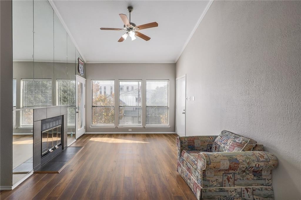 807 West 25th Street, Unit 206 Austin, TX 78705 - Photo 1 of 7 a living room with furniture and a floor to ceiling window