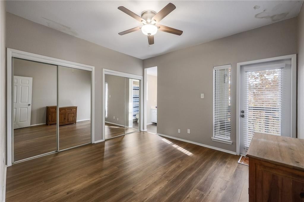 807 West 25th Street, Unit 206 Austin, TX 78705 - Photo 3 of 7 an empty room with wooden floor and a ceiling fan
