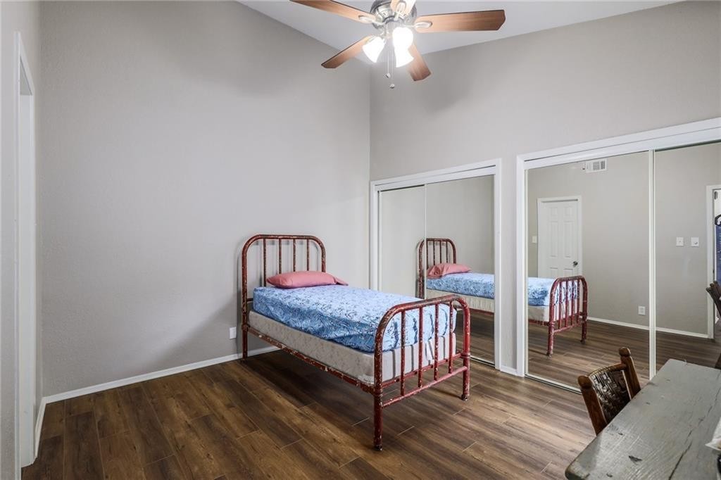 807 West 25th Street, Unit 206 Austin, TX 78705 - Photo 4 of 7 a bedroom with a bed and a chandelier