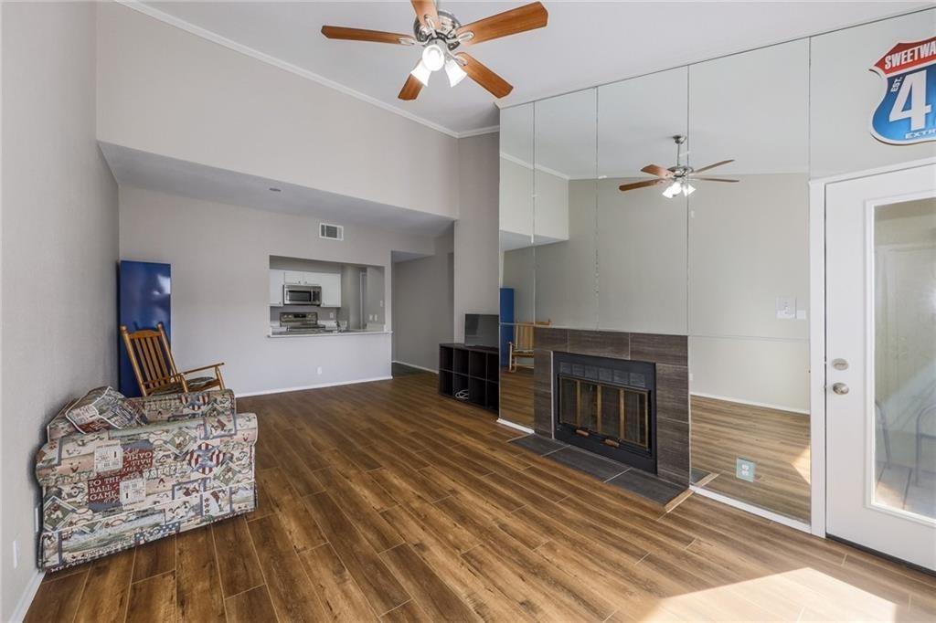 807 West 25th Street, Unit 206 Austin, TX 78705 - Photo 6 of 7 a living room with furniture and a fireplace