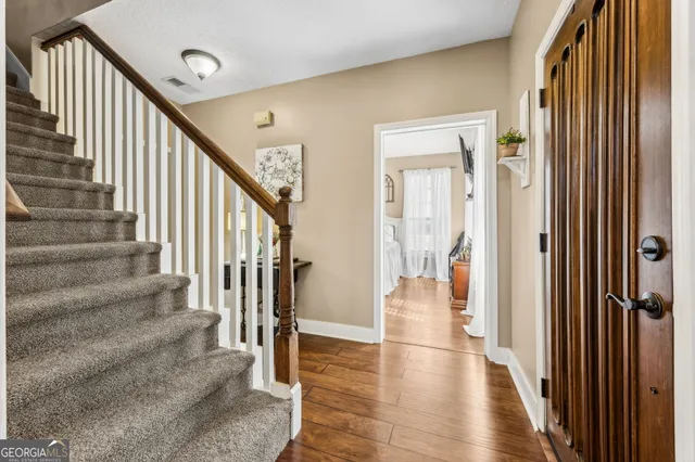 a view of a livingroom with furniture and hardwood floor