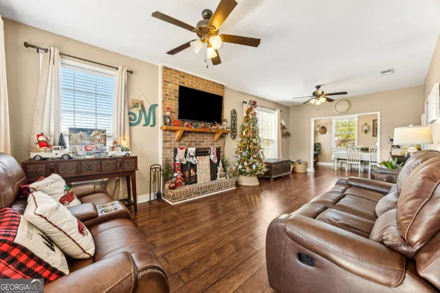 a kitchen with stainless steel appliances a stove a sink dishwasher and cabinets with wooden floor