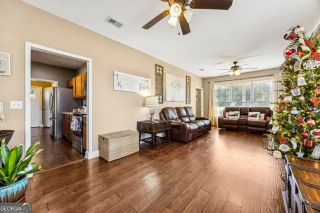 a kitchen with stainless steel appliances a sink a stove and a wooden floors