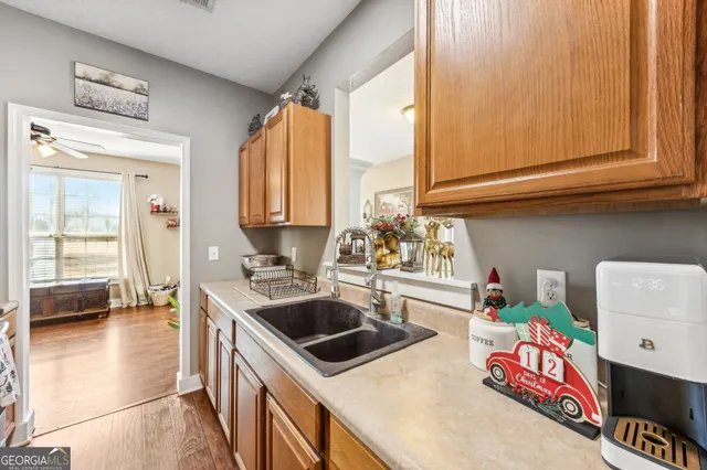 a bathroom with a granite countertop sink a toilet and a shower