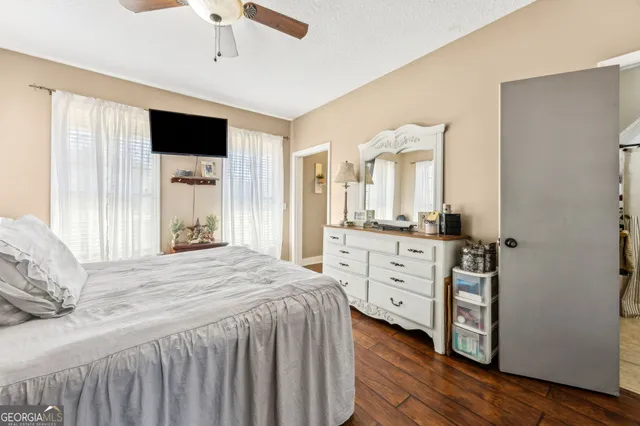 a bedroom with a bed and a ceiling fan