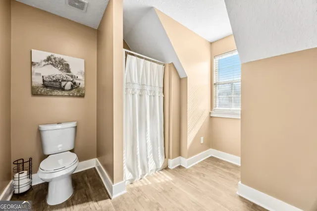 an aerial view of a house with a yard