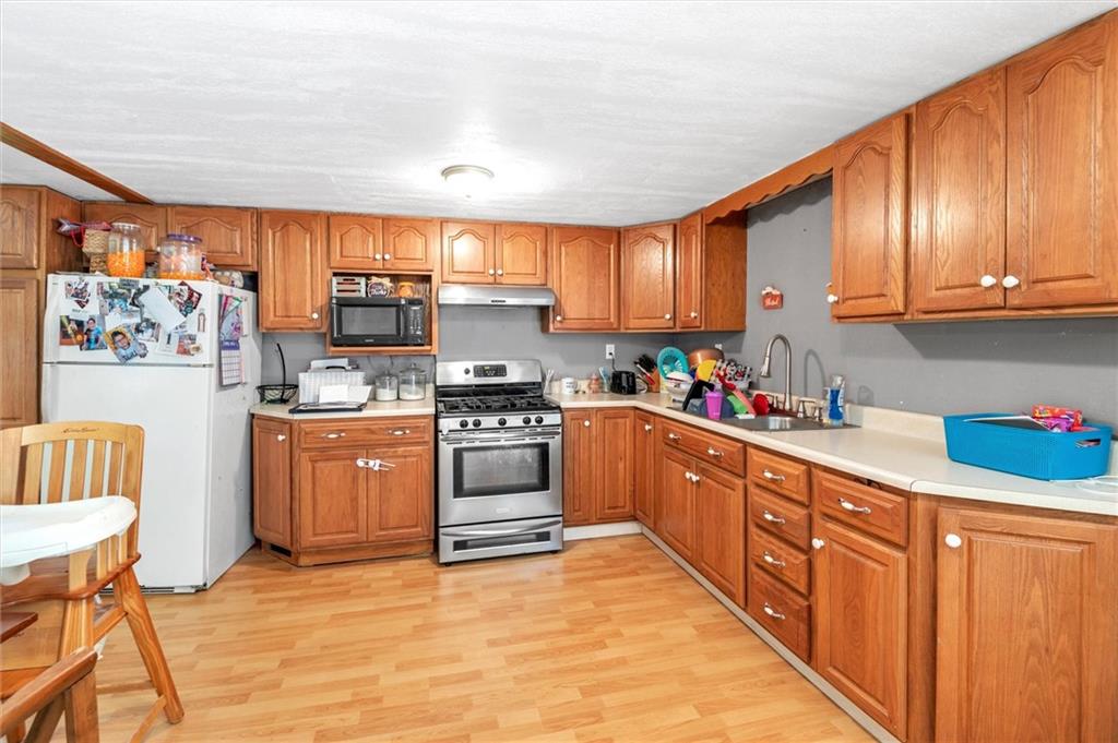 1799 Trusal Road Creekside, PA 15732 - Photo 12 of 24 a kitchen with stainless steel appliances granite countertop a sink window and cabinets