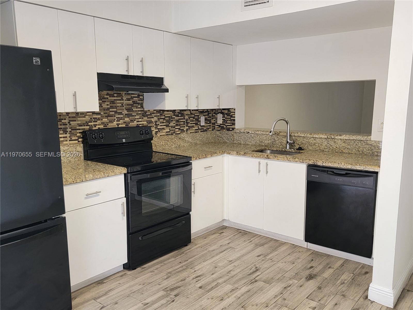 8250 Southwest 149th Court, Unit 8210 Miami, FL 33193 - Photo 13 of 23 a kitchen with a sink and a stove top oven