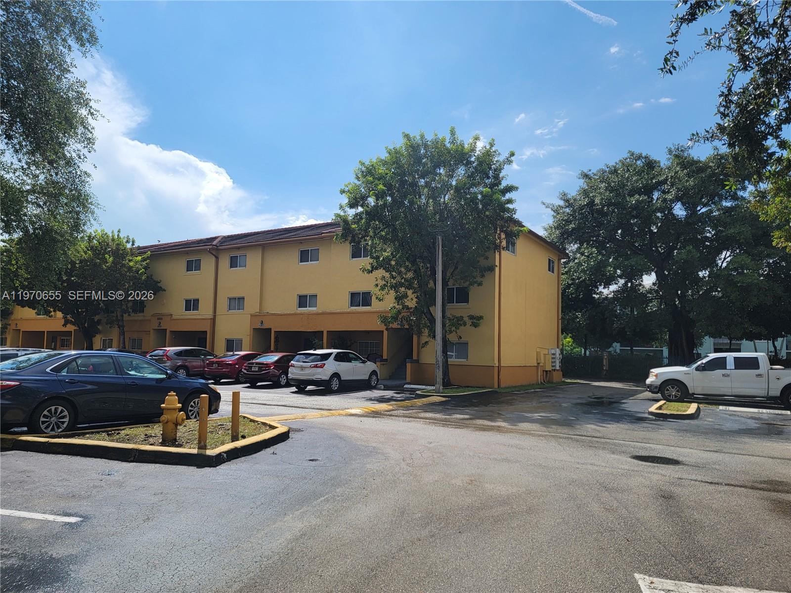 8250 Southwest 149th Court, Unit 8210 Miami, FL 33193 - Photo 2 of 23 a view of swimming pool with outdoor seating and a garden